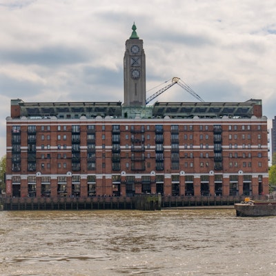 The Oxo Tower with the muddy Thames in the foreground.