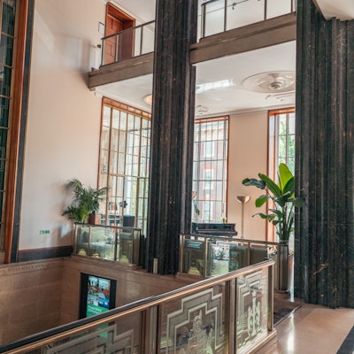 Photo of some art deco columns and glass balcony fencing.