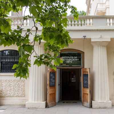 Photo of the door to the gallery, with a tree in the foreground.