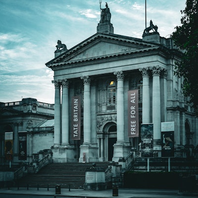 Moody photo of The Tate Britain, with a banner showing "Free for all"