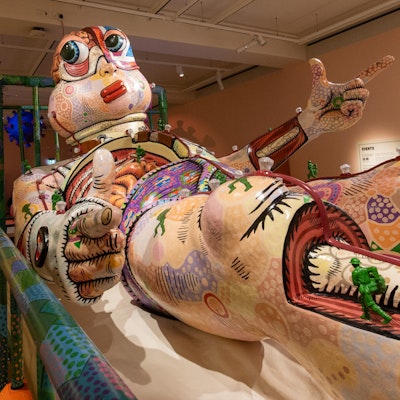 A vibrant sculpture showing a reclined figure