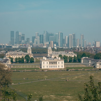 Photo showing a view of Queens House with skyscrapers behind.