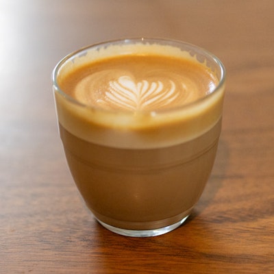 Photo of a flat white in a glass cup