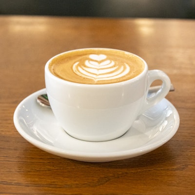 Photo of a flat white in a white cup.