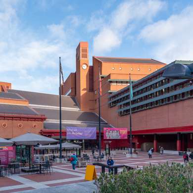 Photo of the courtyard of the British Library showing a modernist clocktower in the background.