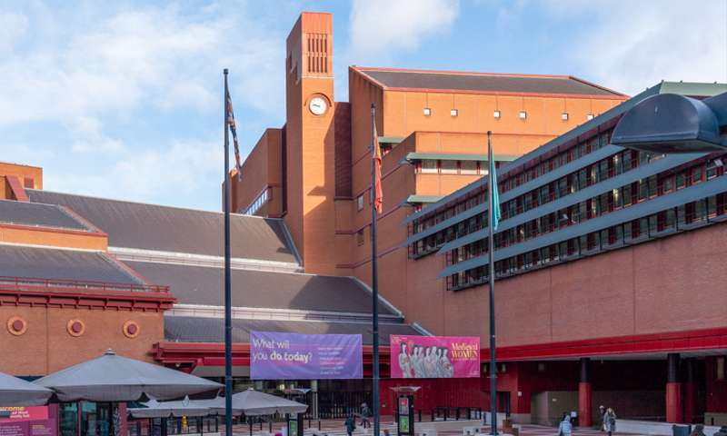 Photo of the courtyard of the British Library showing a modernist clocktower in the background.