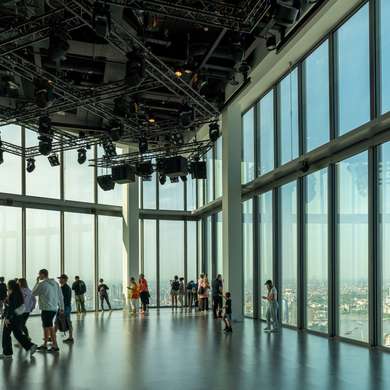 Photo of people looking out over London in an empty room