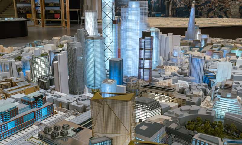 Photo of a scale model of London, with illuminated skyscrapers.