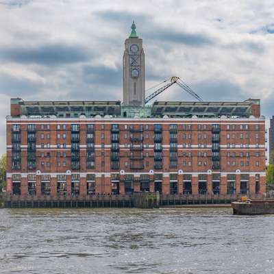 The Oxo Tower with the muddy Thames in the foreground.