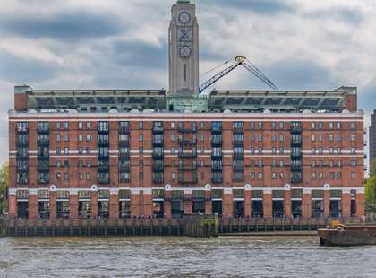 The Oxo Tower with the muddy Thames in the foreground.