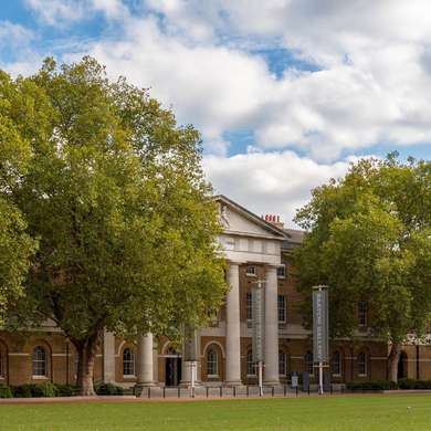 Photo of the exterior of the gallery, a huge brick building with a grand portico