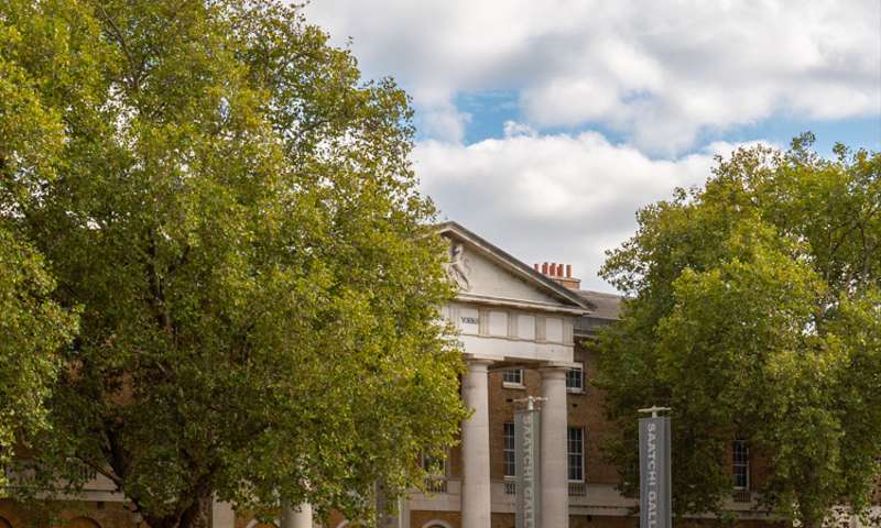 Photo of the exterior of the gallery, a huge brick building with a grand portico