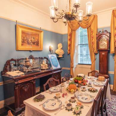 Charles Dickens' dining room with a meal laid out on the table.