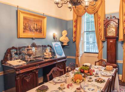 Charles Dickens' dining room with a meal laid out on the table.