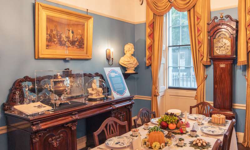 Charles Dickens' dining room with a meal laid out on the table.