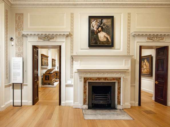 A painting of John the Baptist hanging over a fireplace in the Courtauld Gallery