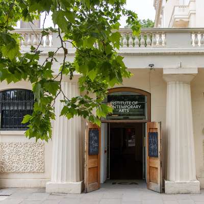 Photo of the door to the gallery, with a tree in the foreground.