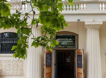 Photo of the door to the gallery, with a tree in the foreground.