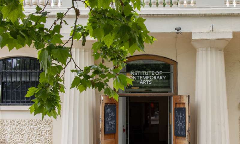 Photo of the door to the gallery, with a tree in the foreground.