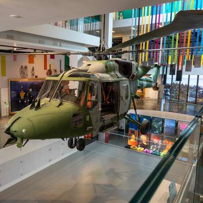 Photo of an army helicopter suspended above an atrium.