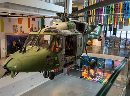 Photo of an army helicopter suspended above an atrium.