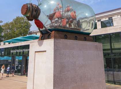 Photo of a sculpture of a boat in a bottle outside the museum.