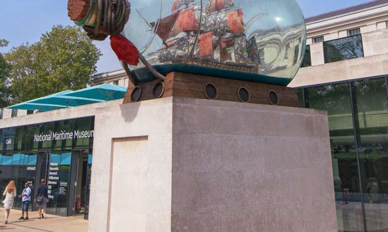 Photo of a sculpture of a boat in a bottle outside the museum.