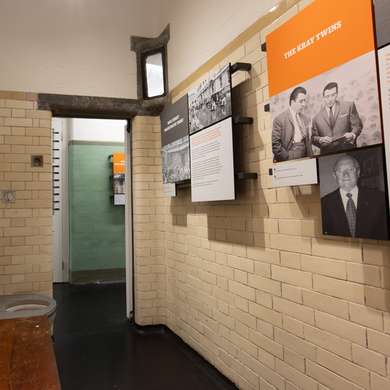 Photo looking outwards from a cell with information boards.