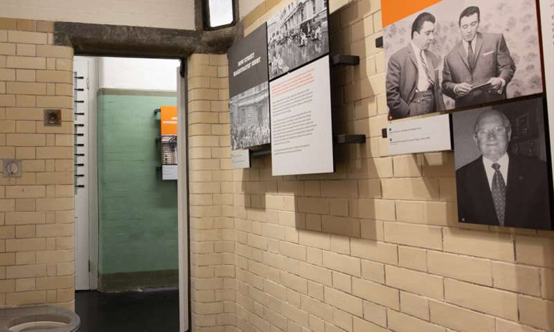 Photo looking outwards from a cell with information boards.