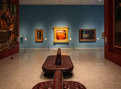 The Collection Gallery at the Royal Academy of Arts,  with the painting "Flaming June" in the background
