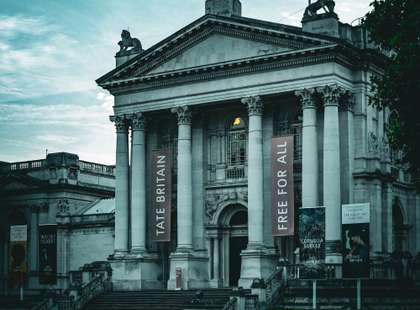 Moody photo of The Tate Britain, with a banner showing "Free for all"