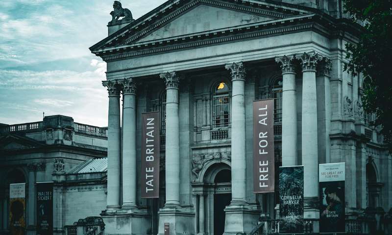 Moody photo of The Tate Britain, with a banner showing "Free for all"