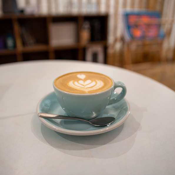 Photo of a flat white in a kind of blueish cup.