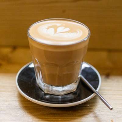 Photo of a flat white in a glass cup